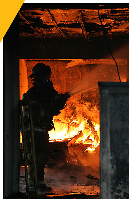 Fire fighter in action in a structure